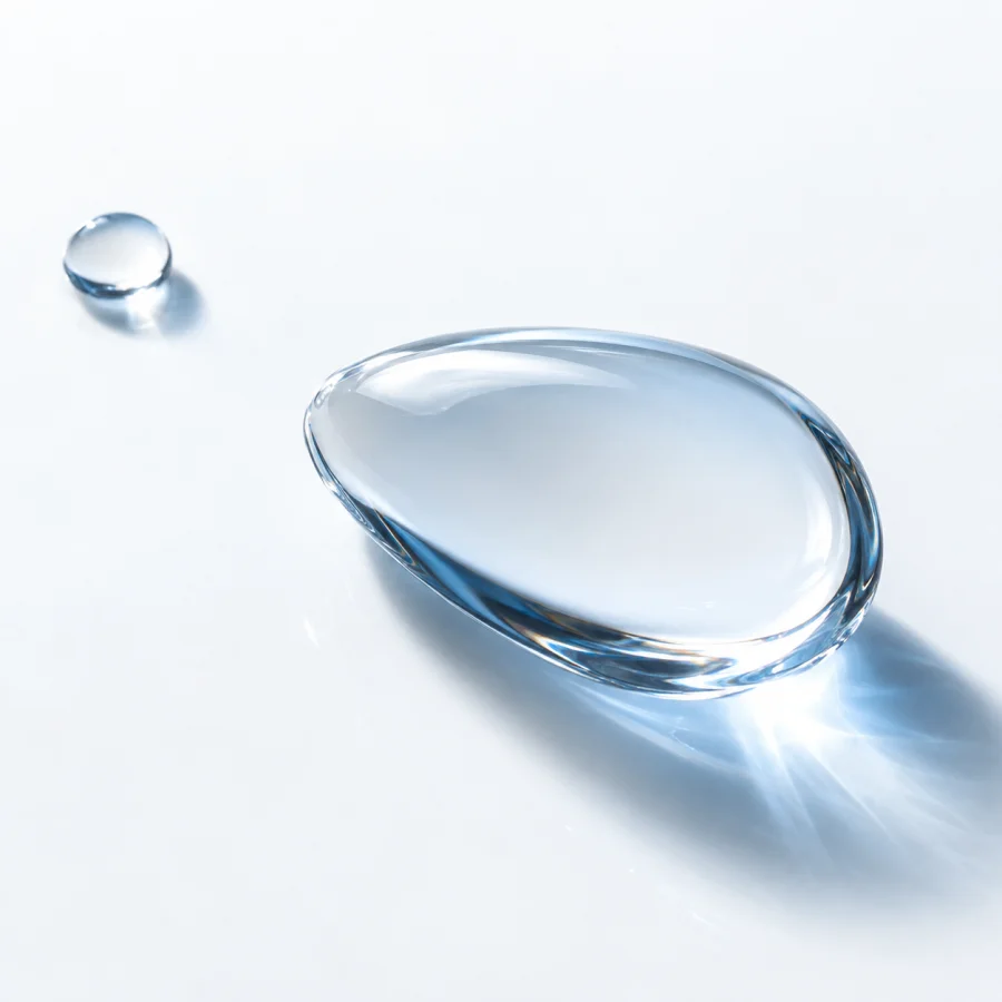 Clear water droplets with soft ice-blue reflections